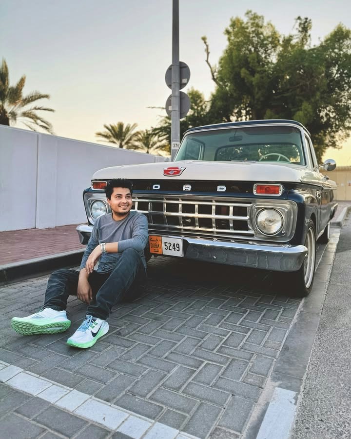 Muhammad Nurul Amin beside a classic Ford pickup